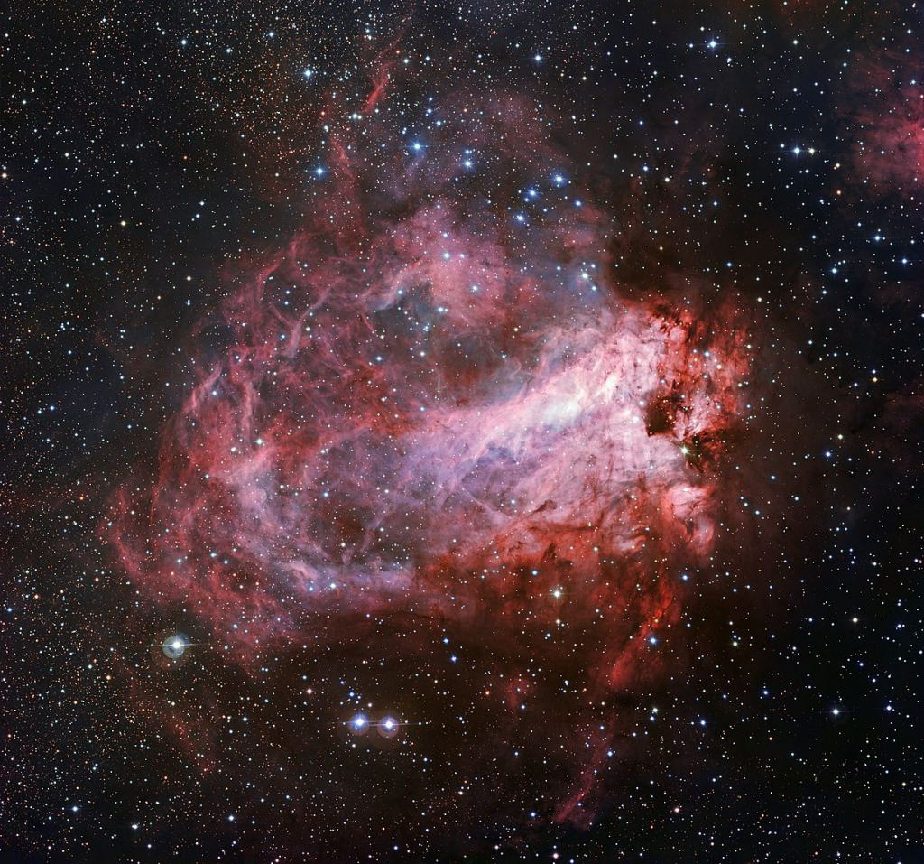 This image of the rose-coloured star-forming region Messier 17 was captured by the Wide Field Imager on the MPG/ESO 2.2-metre telescope at ESO's La Silla Observatory in Chile. It is one of the sharpest images showing the entire nebula, and not only reveals its full size but also retains fine detail throughout the cosmic landscape of gas clouds, dust and newborn stars. Image Credit: By ESO - http://www.eso.org/public/images/eso1537a/, CC BY 4.0, https://commons.wikimedia.org/w/index.php?curid=43587748