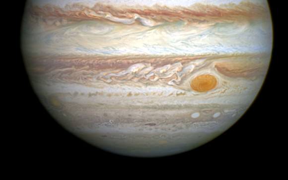 Jupiter's Great Red Spot or GRS is located in a 'bay' or hollow south of the South Equatorial Belt. It's a swirling storm that rises above the cloud tops of the planet and rotates in a counterclockwise direction with a period of about This photo was taken by Hubble on April 21, 2014.
