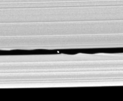 This image shows the moon Daphnis in the Keeler gap in Saturn's A ring. The moon's gravity causes the wave shapes in the rings. By NASA/JPL/Space Science Institute - http://www.esa.int/SPECIALS/Cassini-Huygens/SEM1XQ5TI8E_1.html, Public Domain, https://commons.wikimedia.org/w/index.php?curid=17953334