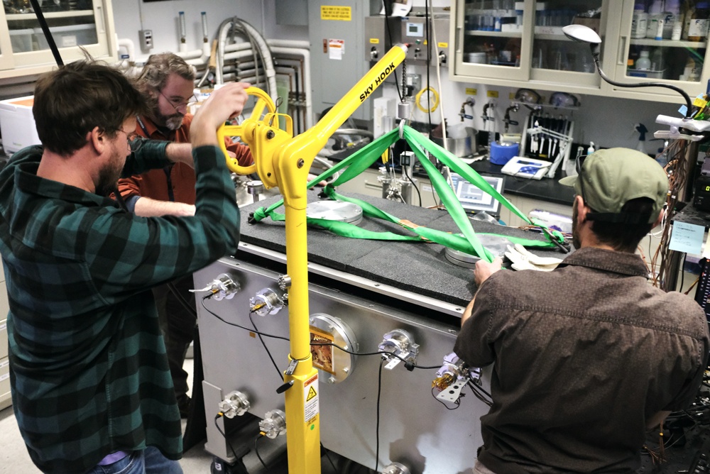 Members of the Ocean Worlds Lab team at NASA’s Jet Propulsion Laboratory (JPL) in Southern California open the Ark, a precise pump-driven vacuum chamber, after a six-month experiment designed to simulate the conditions at and below the surface of Jupiter’s moon Europa. Credit: NASA/JPL-Caltech/J. Thompson