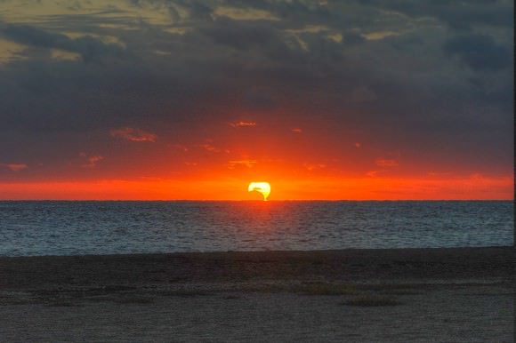 A spectacular 'mirage' view of the partial solar eclipse rising into the clouds, as seen from Fort Pierce, Florida, on November 3, 2013. Credit and copyright: John O'Connor/nasatech.
