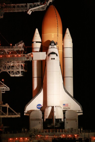 Close up of Space Shuttle Atlantis and crew walk out arm and platform at 195 ft level of pad 39 A.  Close out crew assists crew into their seats. Thereafter the orbiter hatch is closed for the 11 day mission to the ISS.  The arm swings away a few minutes prior to launch.   Credit: Ken Kremer