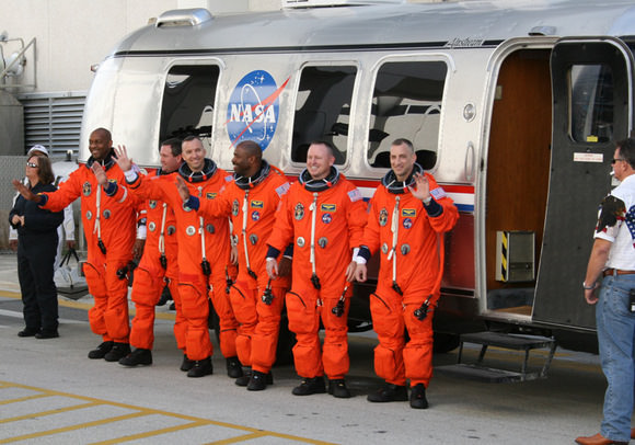 The six person crew of Space Shuttle Atlantis walk out from crew quarters at 10:38 AM to greet the cheering crowd of media and NASA officials and then head out to pad 39 A to strap in for space launch with hours.  Credit: Ken Kremer