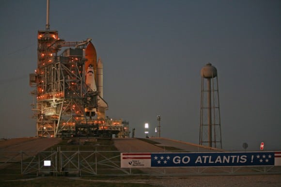 The protective Rotating Service Structure is about halfway through its 25 minute long rollback at dusk on 15 November 2009 to expose Atlantis for launch at Kennedy Space Center Pad 39 A.  Credit: Ken Kremer