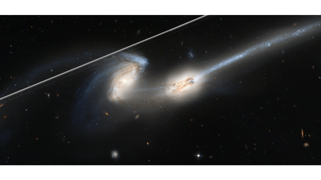 This image captures the streak of an Earth-orbiting artificial satellite crossing Hubble's field of view during an observation of