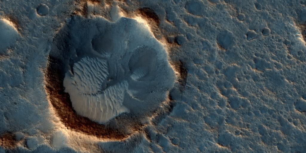 Mars may be a dry, frigid, lifeless planet. But it's still oddly captivating and haunting, probably because we know that Earth will one day resemble it. This May 2015 image from the HiRISE camera on NASA's Mars Reconnaissance Orbiter shows a location on Mars associated with the best-selling novel and Hollywood movie,